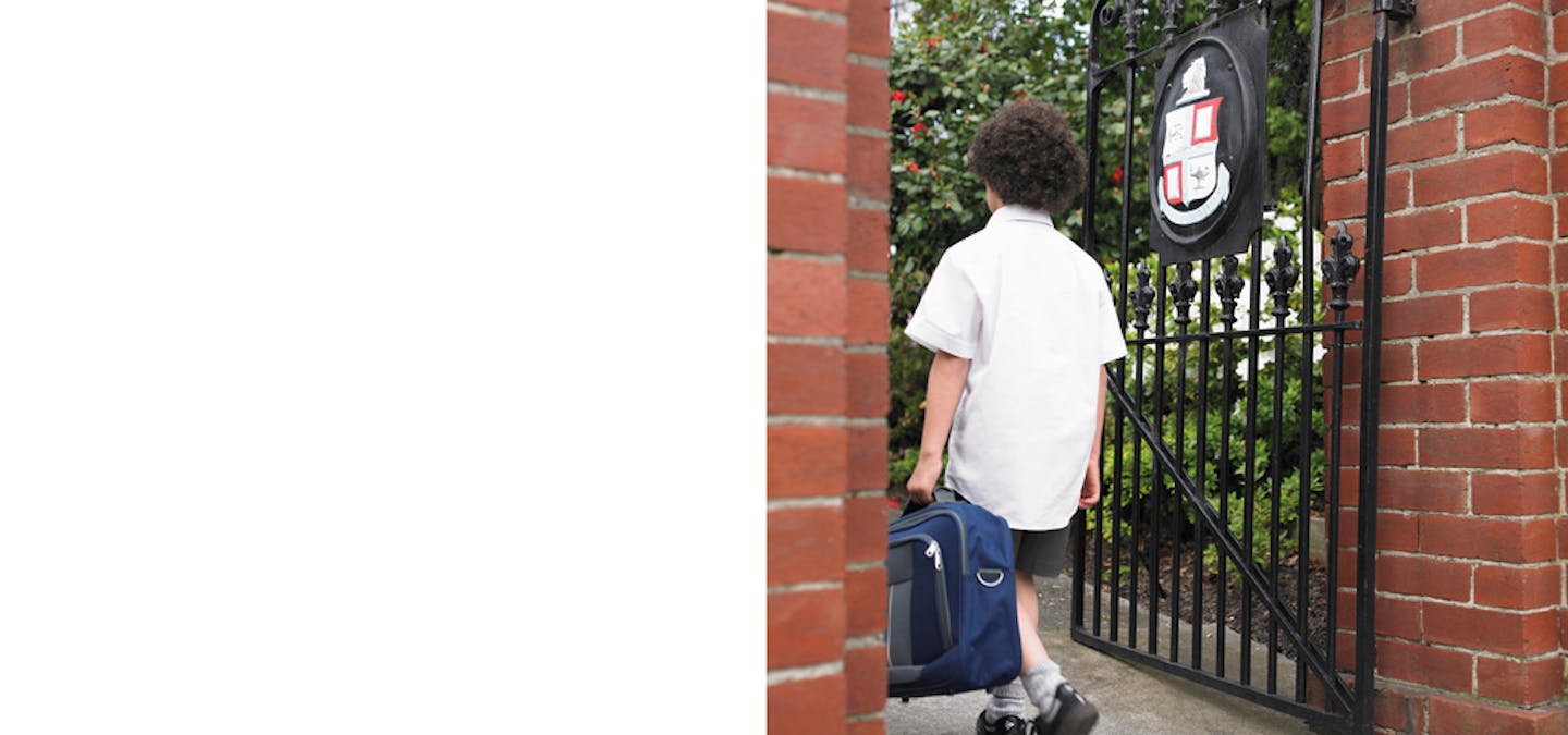 boy leaving school by gates